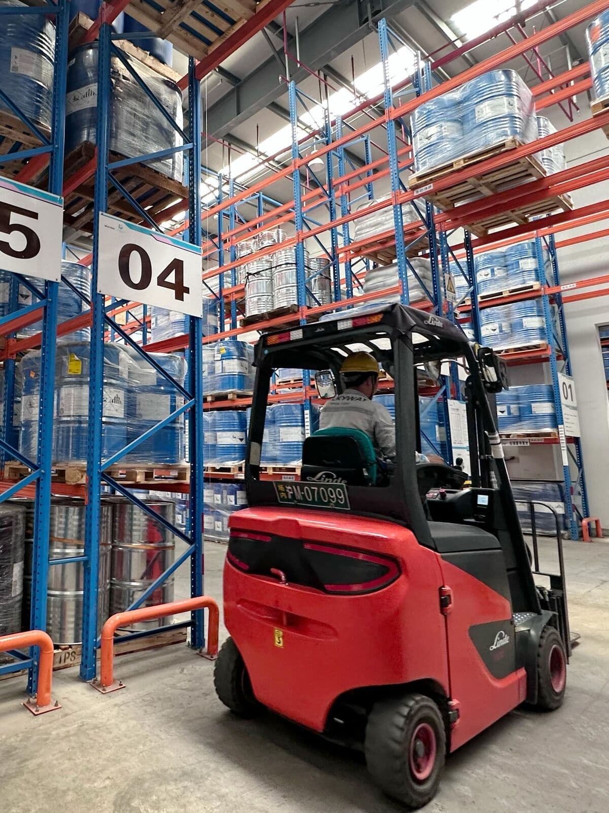 Forklift operating in ChinaPAM warehouse with chemical drums