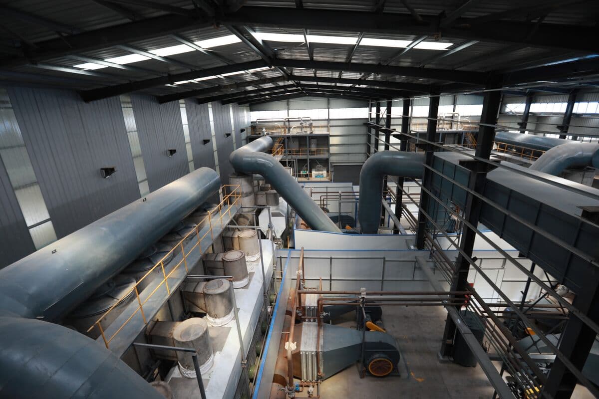 Elevated view of PAM production hall with reactor vessels and piping systems