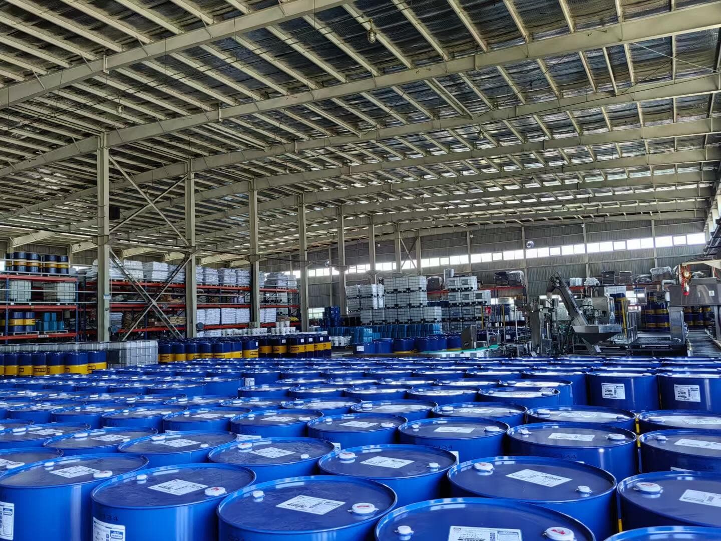 Large warehouse filled with blue chemical drums ready for export